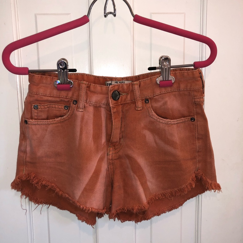 FREE PEOPLE distressed burnt orange denim shorts!